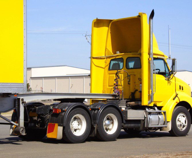 A yellow truck is parked in the lot